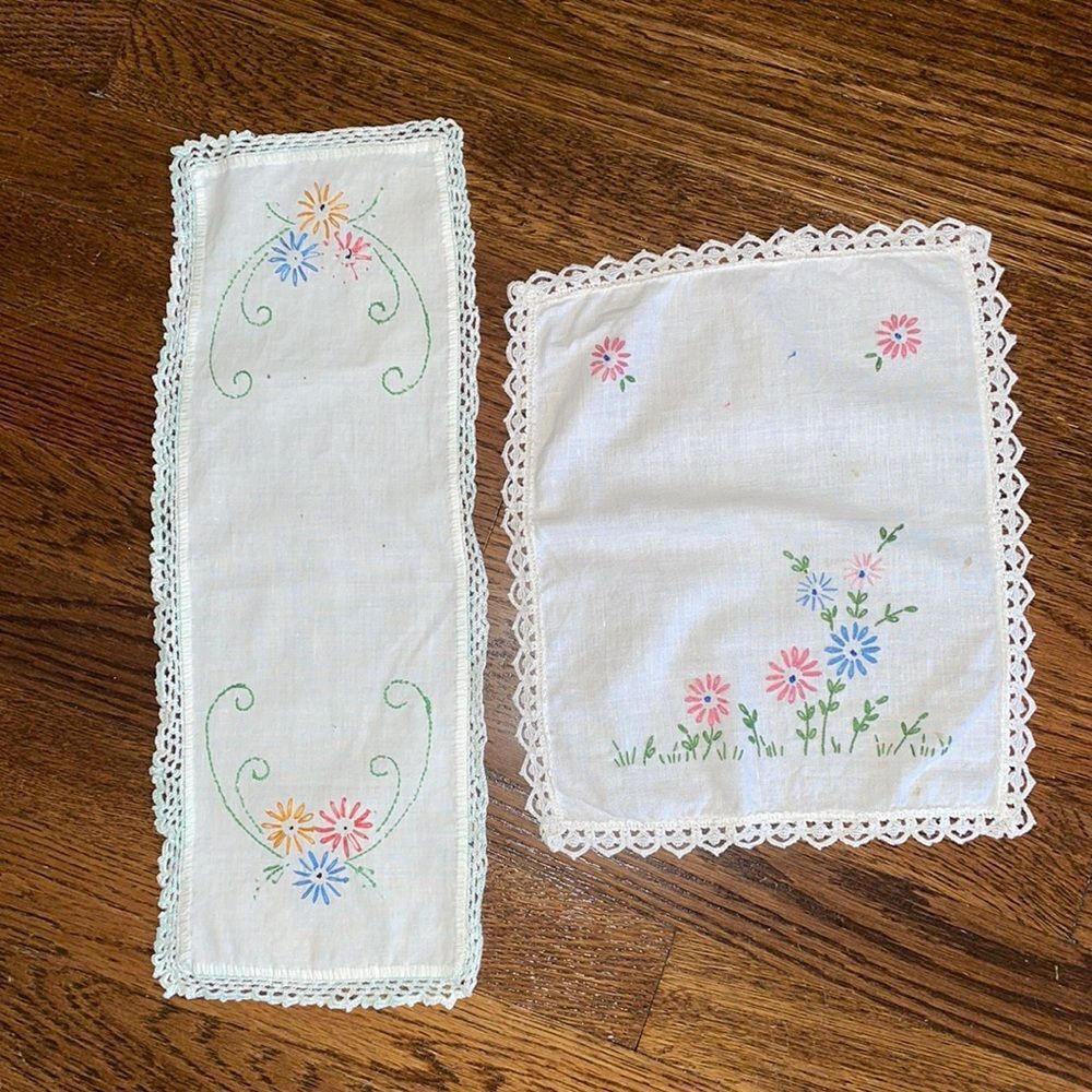 Two small white cotton table doilies with floral embroidery & crochet edges
